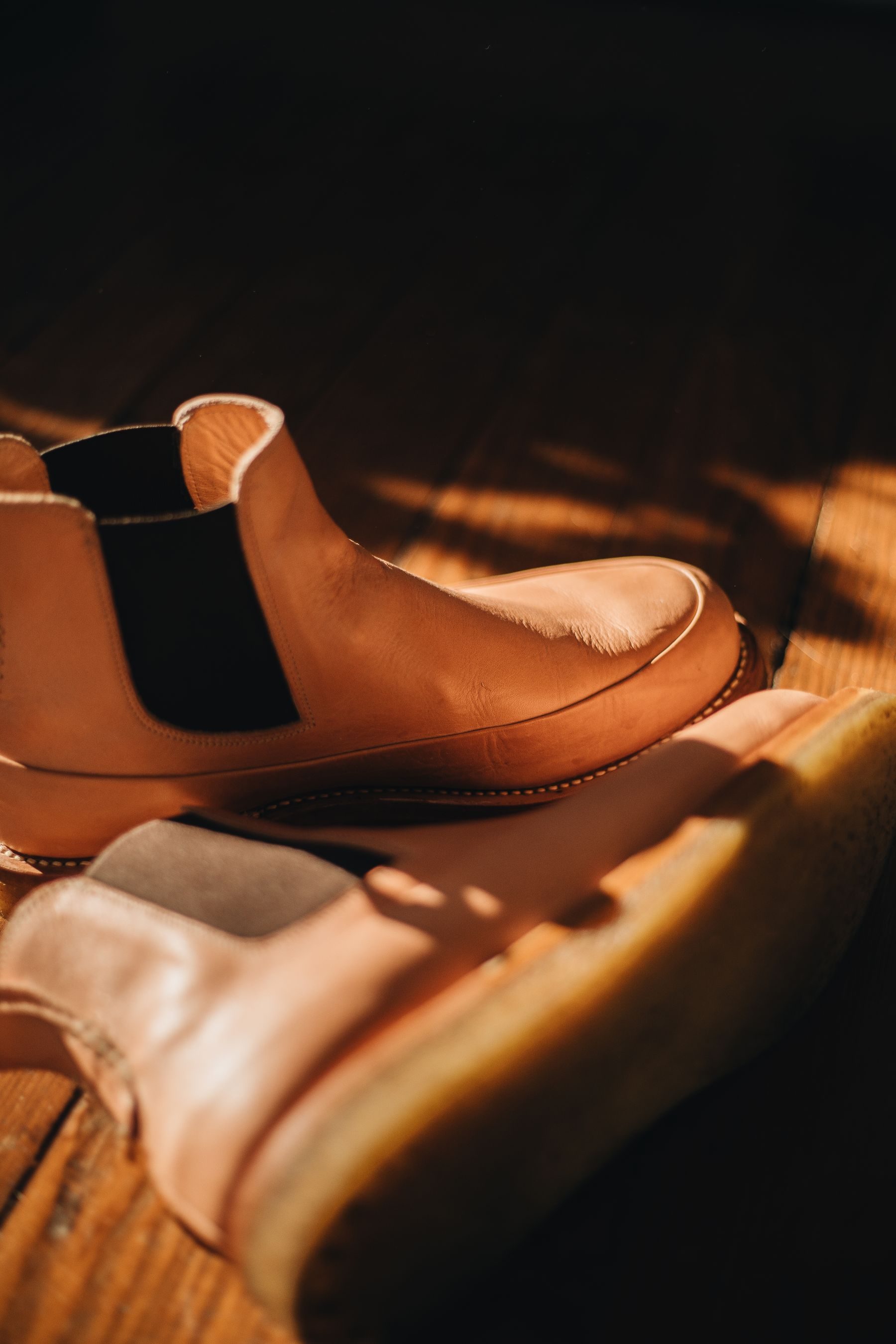 Tan leather Chelsea boots in warm afternoon light
